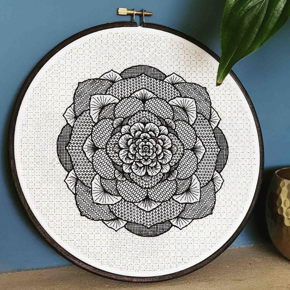An embroidery hoop with a blackwork succulent design embroidered in the middle
