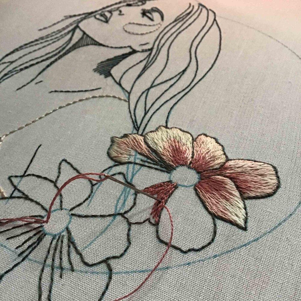 A modern line-style portrait embroidered with neutral coloured flowers