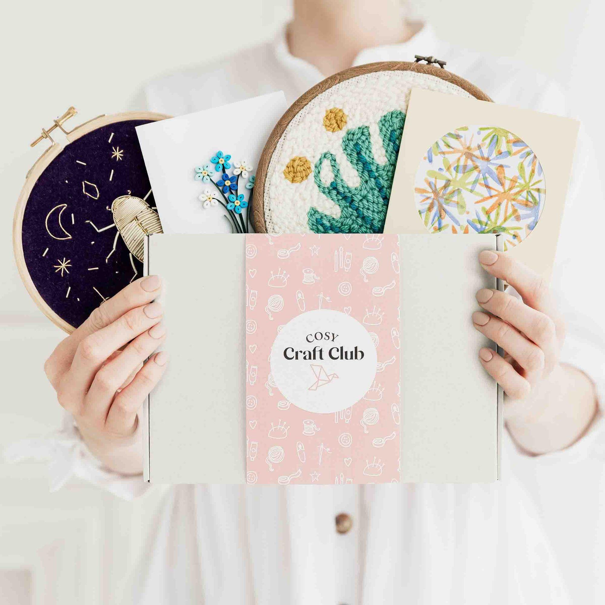 Cosy Craft Club box surrounded by colourful craft projects